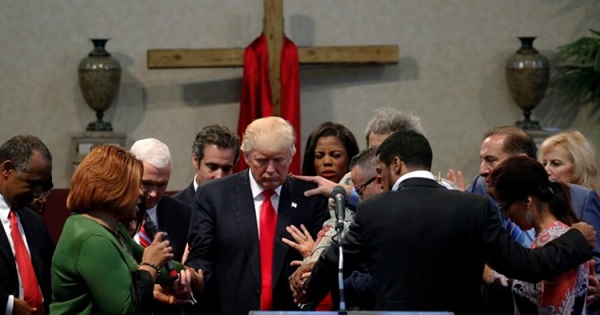 Clergy lay hands and pray over Donald Trump at the New Spirit Revival Center in Cleveland Heights, Ohio, Sept. 21, 2016.