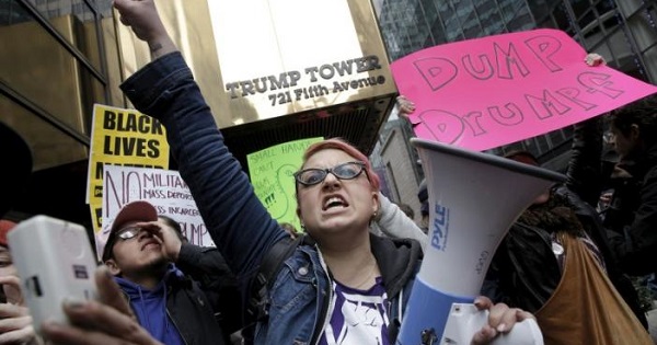Demonstrators protest against Donald Trump, outside the Trump Tower building in midtown Manhattan in New York March 19, 2016.