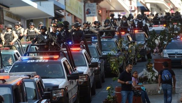 Federal police drive through a street after they were sent to the city to boost security and to restore calm to the state, in Veracruz, Mexico, March 1, 2017.