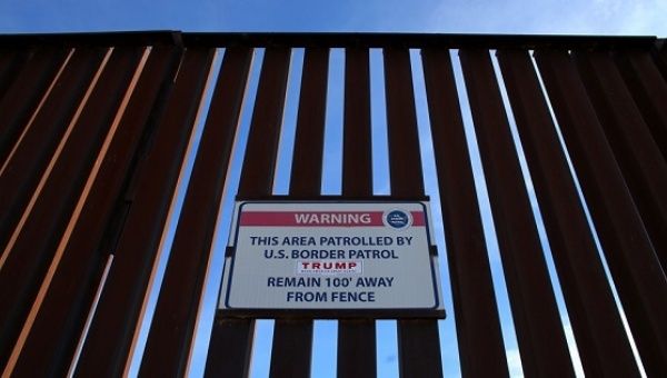  A Donald Trump campaign sticker is shown attached to a U.S. Customs sign on the border fence between Mexico and the United States near Calexico, California.