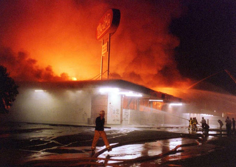 April 29, 1992: Flames roar from a Thrifty Drug store in the Crenshaw area of Los Angeles. 