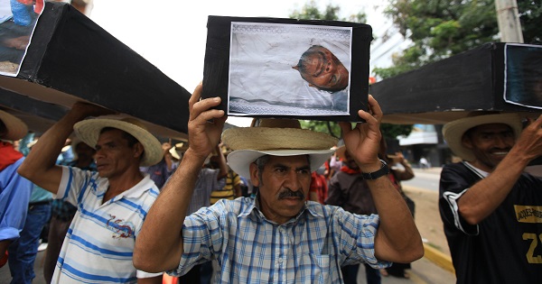 Campesinos march with mock coffins with images of victims from the Aguan Valley region during a demonstration in Tegucigalpa, Honduras, Sept. 15, 2012.