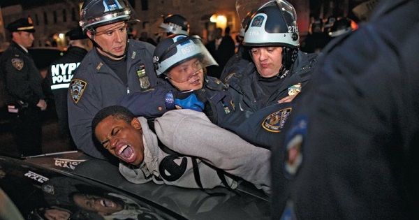 Cops arrest an activist peacefully protesting the police shooting of 16-year-old Kiki Gray in New York City, 2013.