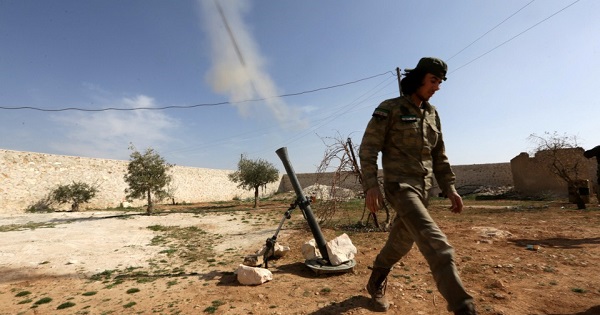 A Turkey-backed rebel fighter fires a mortar shell towards Syrian regime soldiers, west of Manbij city, in Aleppo Governorate, Syria, March 9, 2017.