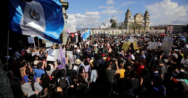 People protest to demand justice for the victims of a fire at the Virgen de Asuncion children's shelter, in front of the National Palace in Guatemala City.