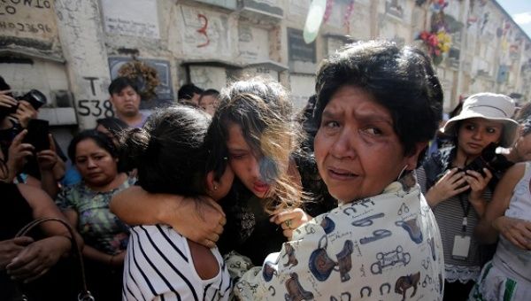 Friends and family attend the funeral of a victim of the fire at the Virgen de Asuncion children shelter, at the cemetery in Guatemala City.