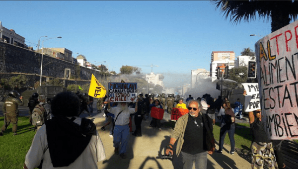 Police fire tear gas at TPP protesters in Chile.
