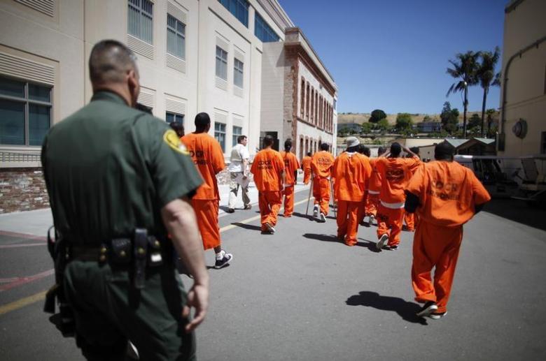 Inmates are escorted by a guard through San Quentin state prison in California, June 8, 2012.