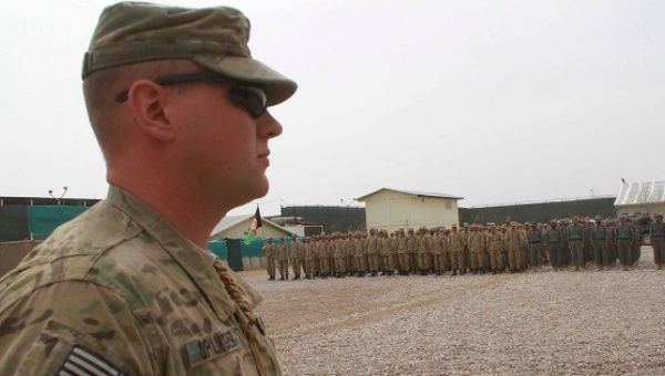U.S. soldiers of the NATO's troops in Afghanistan attends the graduation ceremony of Afghan police forces in Herat, Afghanistan, March 15, 2012.