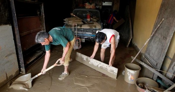 People remove mud from a house after a landslide and a flood occurred in San Juan de Lurigancho distritct, in Lima, Peru.