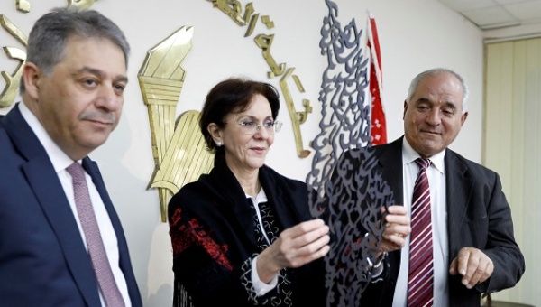 Palestinian Ambassador to Lebanon stands next to U.N. Under-Secretary General Khalaf while she holds a gift after a news conference announcing her resignation.