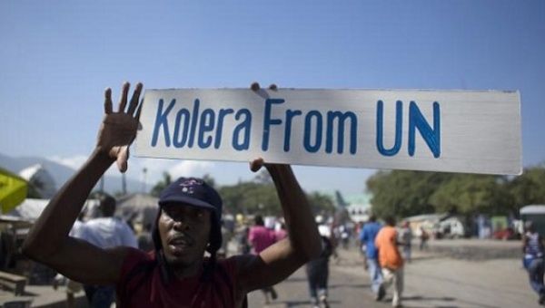 A protester holds up a sign during a demonstration against the U.N. mission in downtown Port-au-Prince, Nov. 18, 2010. 