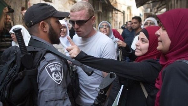 Palestinian women argue with Israeli policemen during a protest at the Temple Mount in Jerusalem, Sept. 16, 2015.
