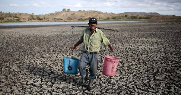 A farmer carries buckets of water in Palyitas town, Nicaragua, March 3, 2016.