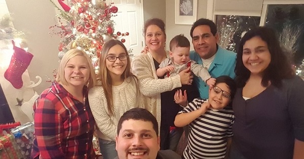 Trump supporter Helen Beristain (C) holding her grandchild is shocked her husband Roberto (R-blue shirt) will be deported
