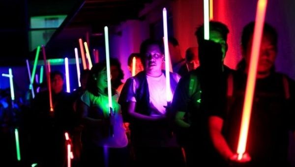 Star Wars enthusiasts raise their lightsabers as they participate in the annual Earth Hour, Taguig city, Manila, Philippines Mar. 25, 2017. 