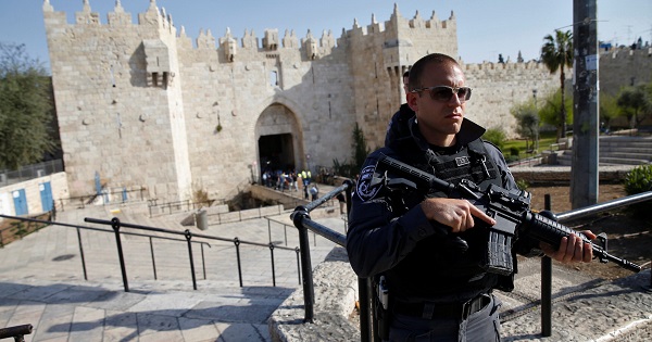 An Israeli policeman stands guard near the scene at Damascus Gate where a Palestinian woman was shot dead in Jerusalem, March 29, 2017.