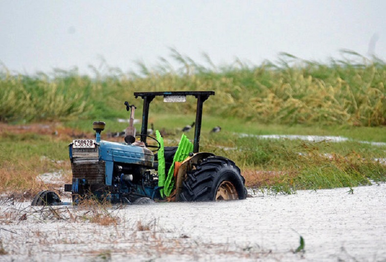 A tractor sits in a flooded sugar cane field after Cyclone Debbie passed through the area near the northern Australian town of Bowen, located south of Townsville in Australia.