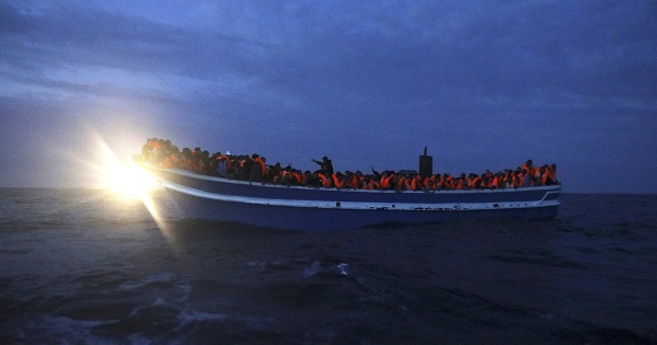 Refugees are seen on board a drifting overcrowded wooden boat, during a rescue operation by the Spanish NGO Proactiva Open Arms, March 29, 2017.