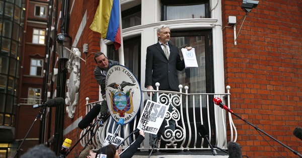 WikiLeaks founder Julian Assange holds a copy of a U.N. ruling as he makes a speech from the balcony of the Ecuadorian Embassy, London, U.K., Feb. 2016.