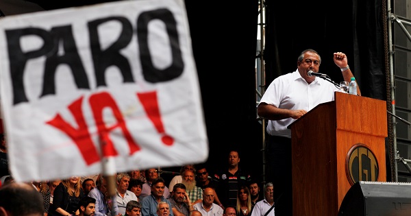 Hector Daer, secretary-general of the CGT union addresses a crowd in Buenos Aires, next to him a sign that reads 