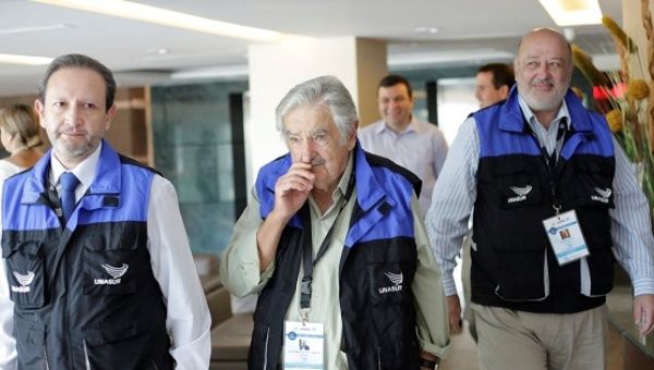 Uruguay's former President Jose Mujica (C) arrives with delegates of the Union of South American Nations, UNASUR.