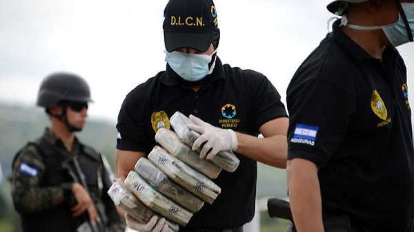 Anti-narcotics and military police officers prepare everything for the incineration of more than 200 kilos of cocaine seized in southern Honduras.