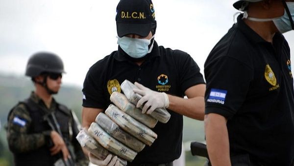 Anti-narcotics and military police officers prepare everything for the incineration of more than 200 kilos of cocaine seized in southern Honduras. 