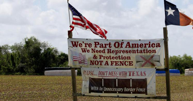 Border residents have long resisted efforts to build a barrier through their land, as shown by this sign near the border in Brownsville, Texas, Sept. 2, 2014.