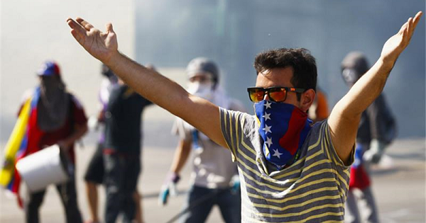 A Venezuelan opposition protester yells at police in Caracas.