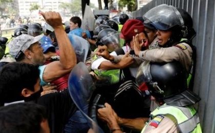 Right-wing protesters attack a Venezuelan police officer in Caracas.