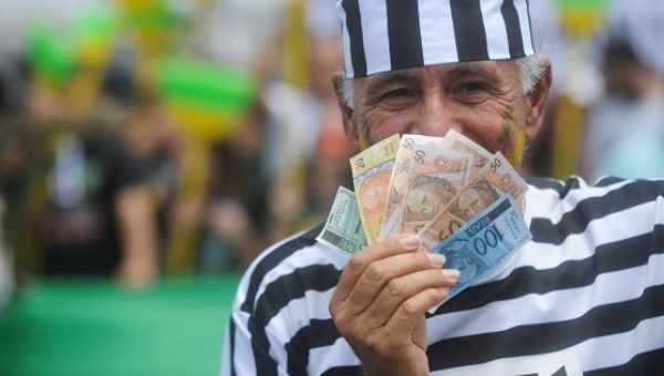 A demonstrator protests against corruption in Brazil, in Brasilia, Oct. 12, 2011.