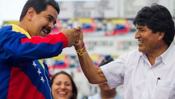 Venezuela's Nicolas Maduro fist bumps Bolivia's Evo Morales.
