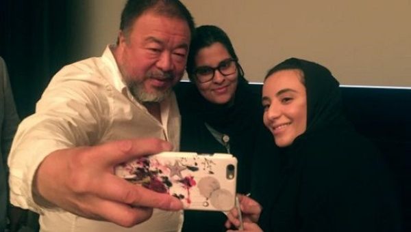 Chinese artist Ai Weiwei takes a selfie with women at the Islamic Art Museum in Doha, Qatar, April 11, 2017.