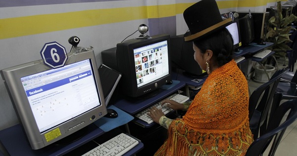 A woman in Bolivia uses free open-source software, which the World Wide Web Consortium is looking to curb.