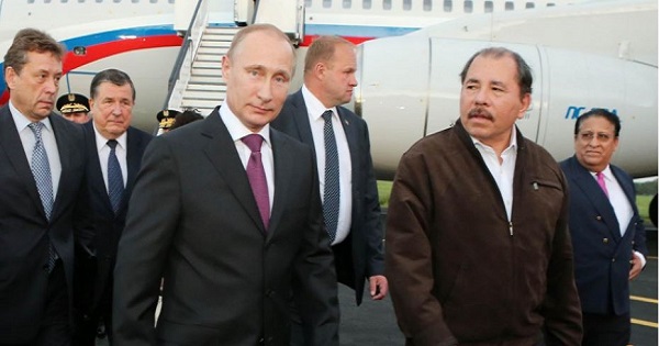 Nicaragua's Daniel Ortega looks towards his guest, Vladimir Putin, after he landed in Managua.