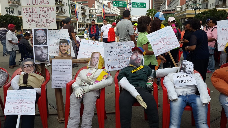 Effigies of opposition leaders are lined up. Chavistas then take turns, via microphone, reading satirical poems describing their feelings towards specific figures.