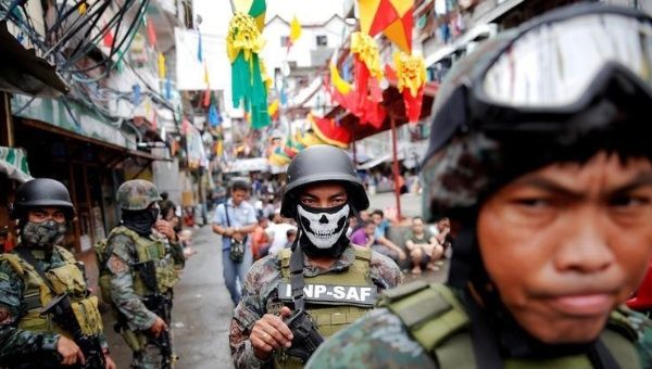 Armed security forces take a part in a drug raid, in Manila, Philippines, Oct. 7, 2016. 