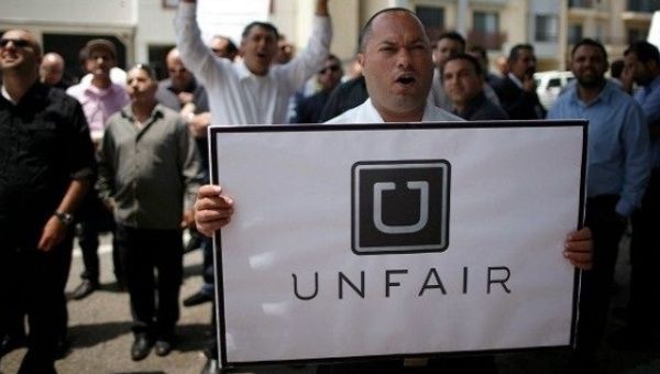 Labor union leaders protest Uber.