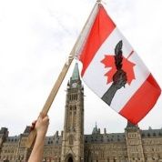A First Nations protester holds a flag during the 