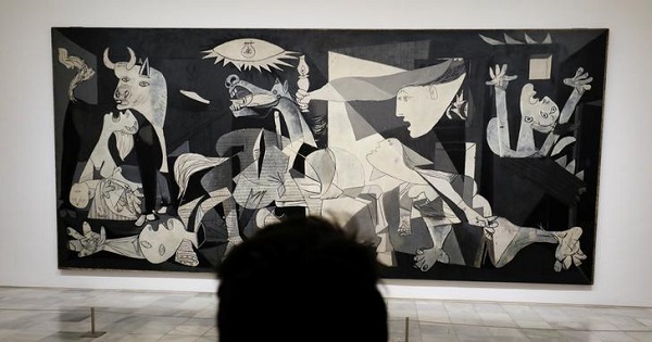 A man looks at Spanish artist Pablo Picasso's masterpiece ''Guernica'' at Madrid's Reina Sofia museum, April 3, 2017.