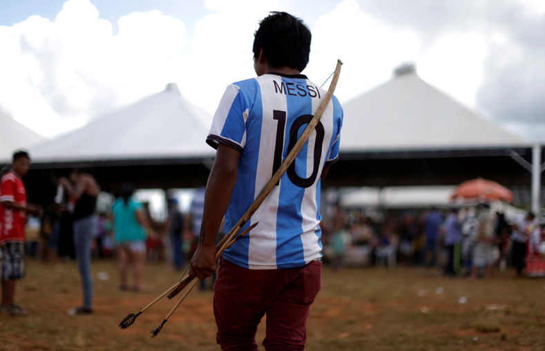 A Brazilian Indigenous person wears a Lionel Messi jersey as he takes part in a demonstration against the violation of indigenous people's rights, in Brasilia, Brazil, April 25, 2017. 