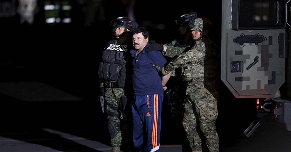 Recaptured drug lord Joaquin 'El Chapo' Guzman is escorted by soldiers in Mexico City, Jan. 8, 2016.