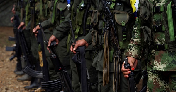 FARC members stand during a formation in a camp before moving to the transitional zone of Pueblo Nuevo, at the Los Robles FARC camp, Colombia, Jan. 25, 2017.