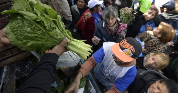 Farmers give away vegetables during a protest at Plaza de Mayo square near the Casa Rosada.