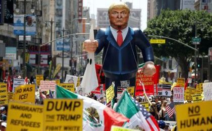 A gigantic Trump effigy is carried down the street during a protest in Los Angeles, CA.
