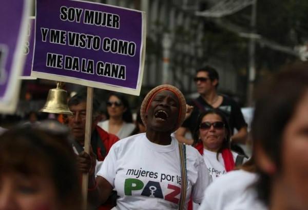 A woman holds a placard during a march in Bogota against crimes and violence against women.