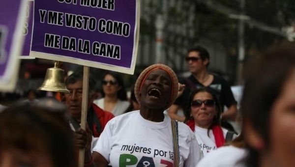 A woman holds a placard during a march in Bogota against crimes and violence against women.