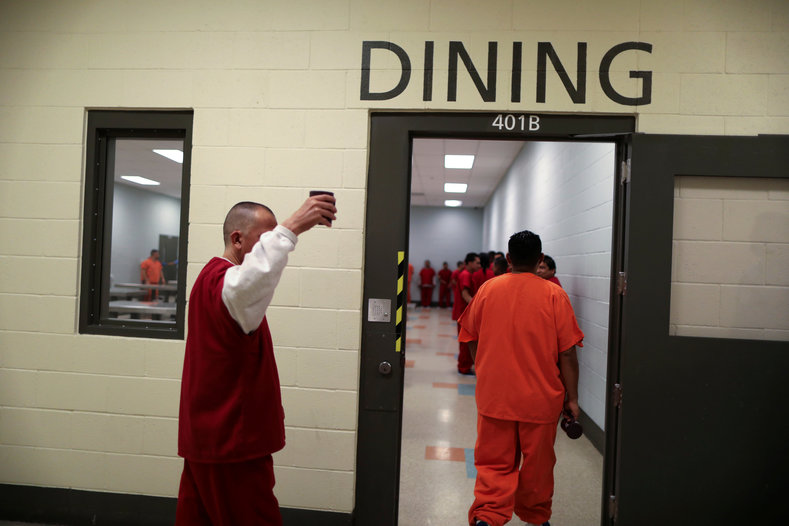 ICE detainees walk into the dining area for lunch.At the facility, some of the detainees could be seen chatting over meals of rice and refried beans, while others sat alone in silence. 