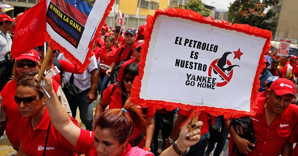 Workers of state-run oil company PDVSA take part in a 2015 rally against U.S. imperialism. The placard reads: 
